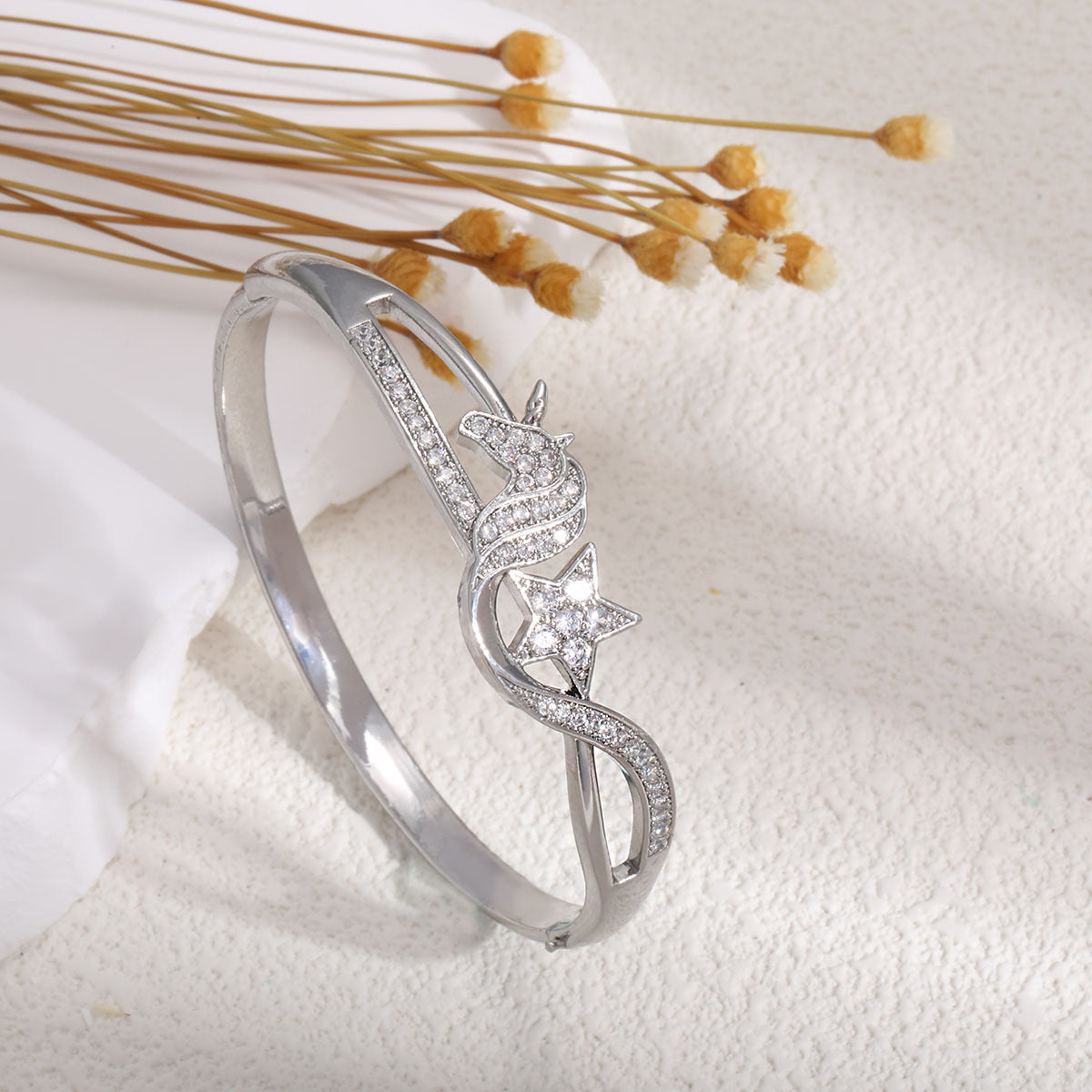 Women's bangle with elegant infinity pattern and sparkling zirconia Style and Serve