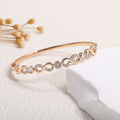 Women's bangle with elegant infinity pattern and sparkling zirconia Style and Serve