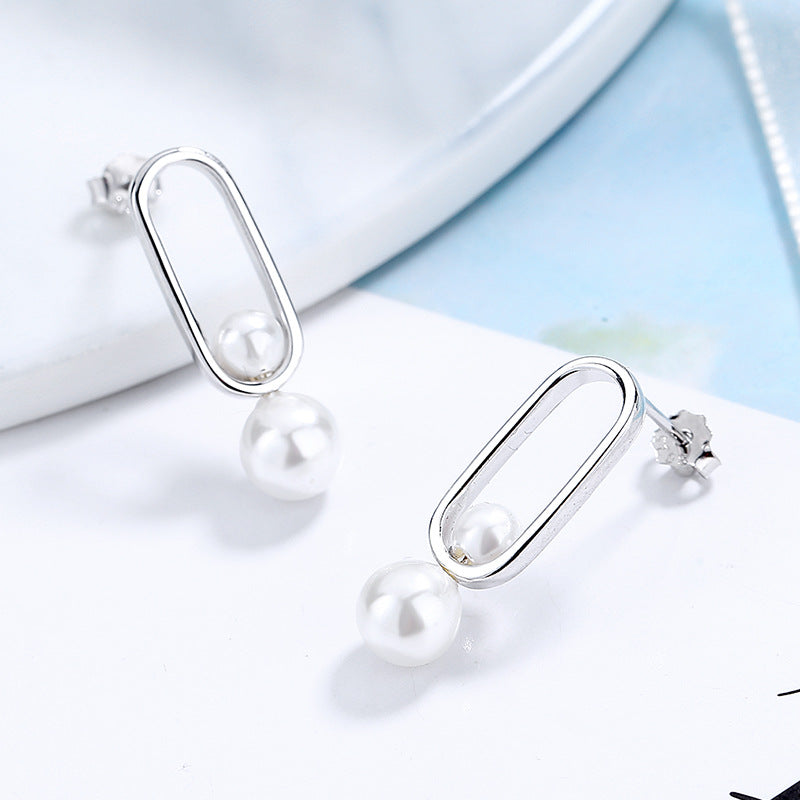 Women's stud earrings with modern oval design and elegant pearls Style and Serve