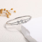 Women's bangle with elegant infinity pattern and sparkling zirconia Style and Serve