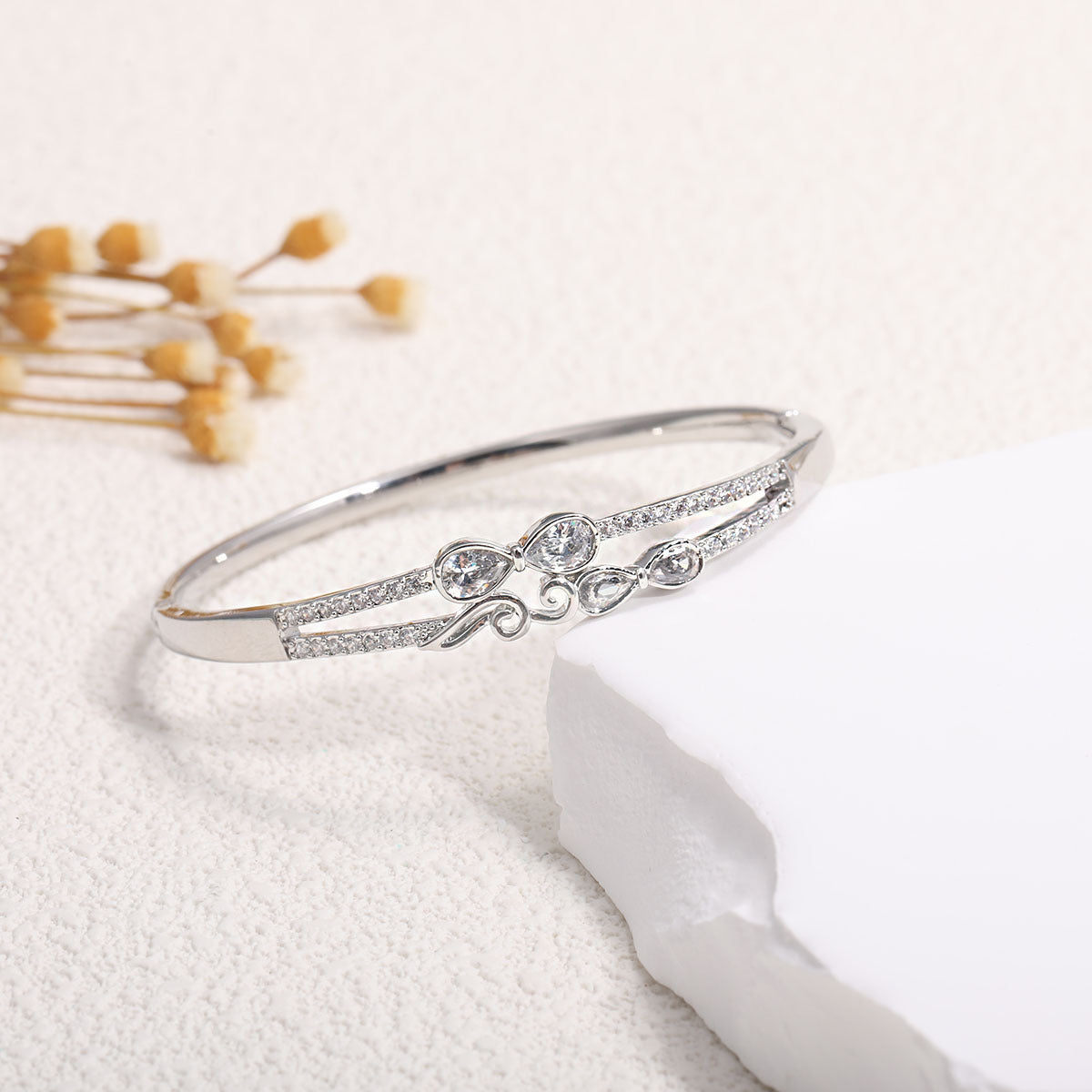 Women's bangle with elegant infinity pattern and sparkling zirconia Style and Serve