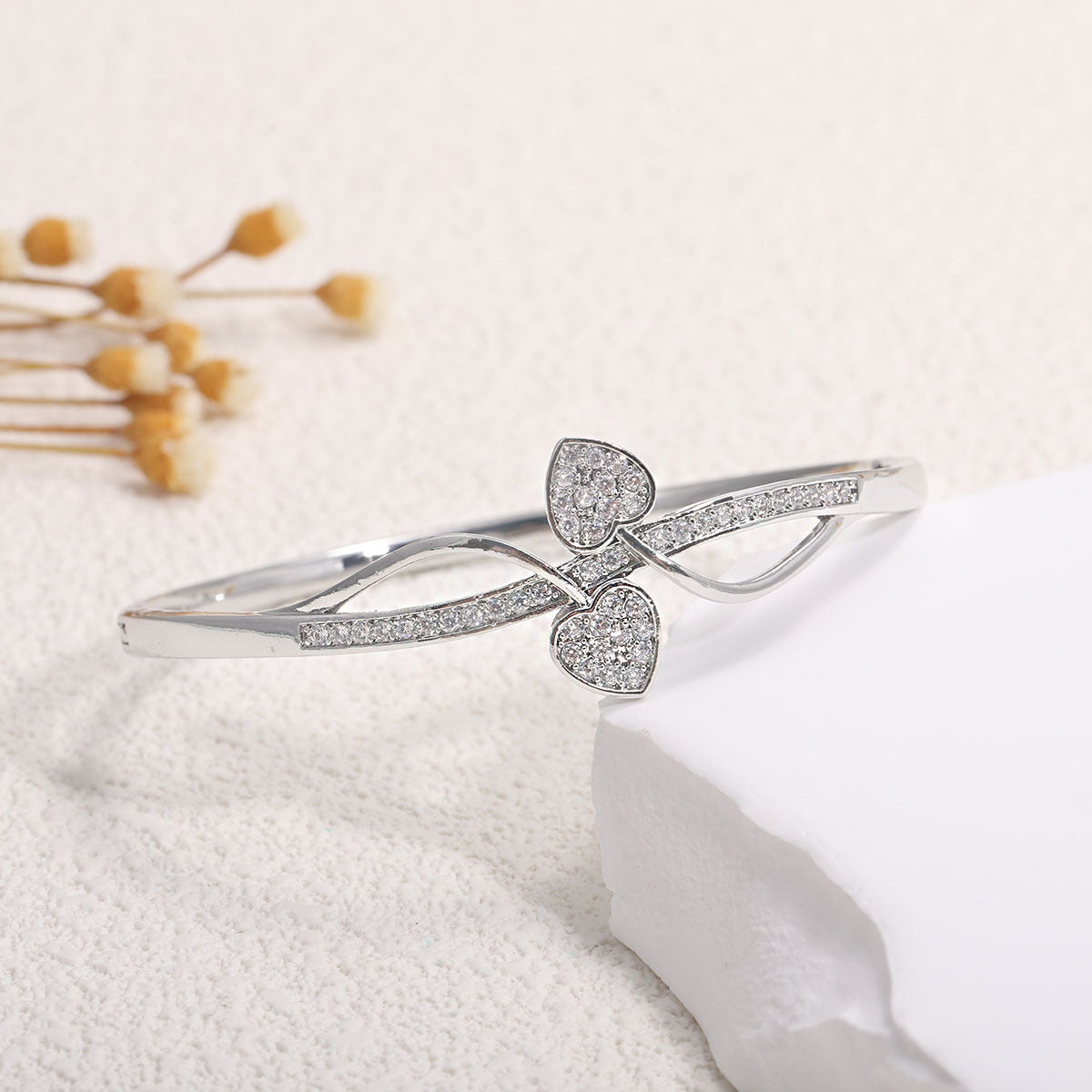 Women's bangle with elegant infinity pattern and sparkling zirconia Style and Serve