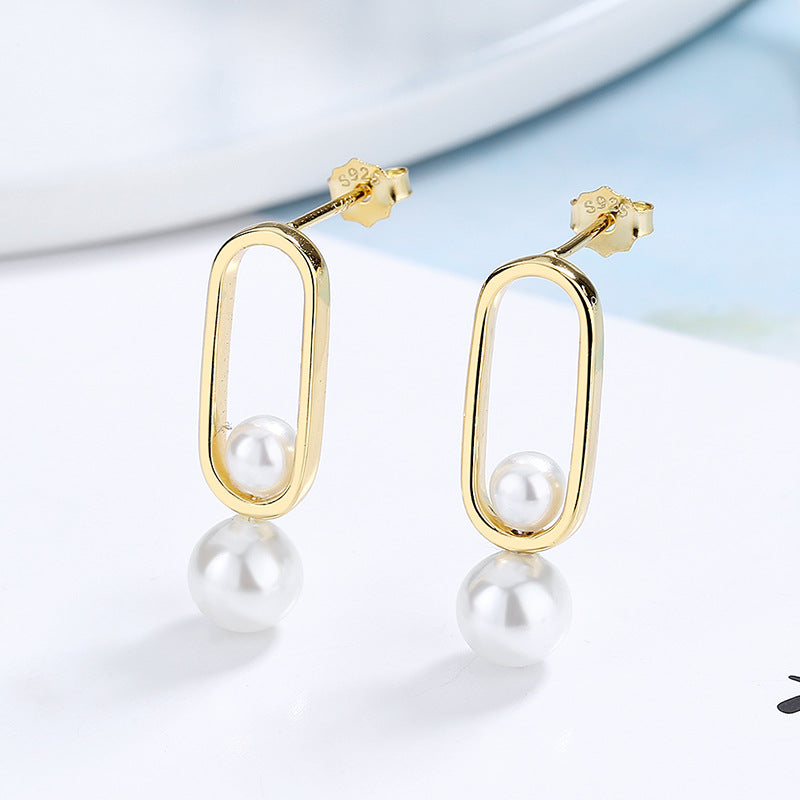 Women's stud earrings with modern oval design and elegant pearls Style and Serve