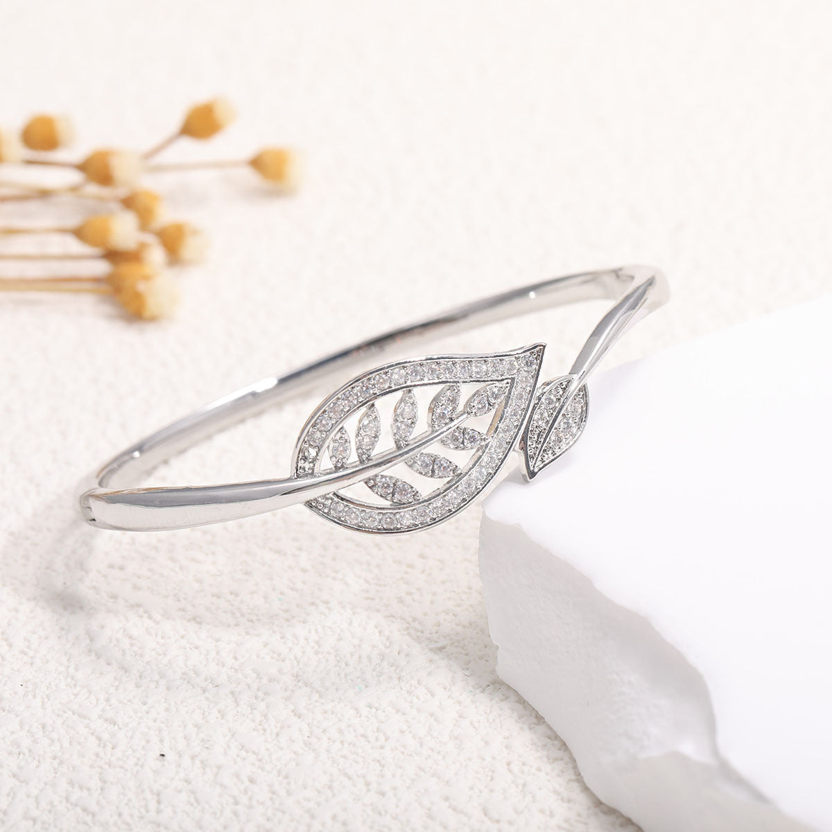 Women's bangle with elegant infinity pattern and sparkling zirconia Style and Serve