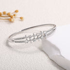 Women's bangle with elegant infinity pattern and sparkling zirconia Style and Serve