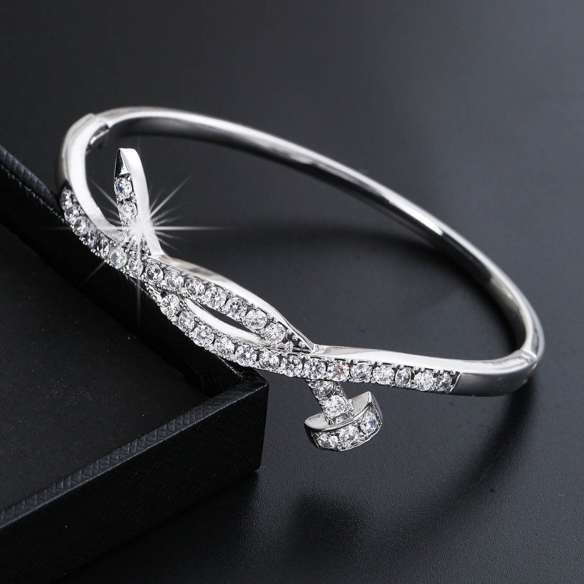 Women's bangle with elegant infinity pattern and sparkling zirconia Style and Serve